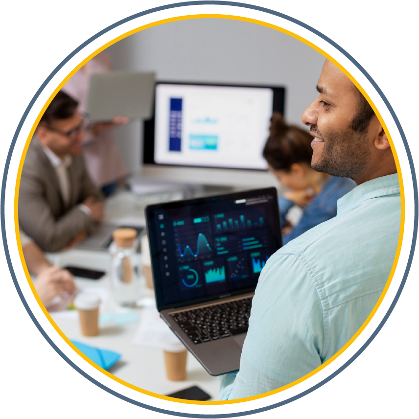 A diverse team collaborating on a project using laptops and tablets in a bright, modern office.